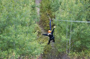 A happy camper riding the Shekinah zipline