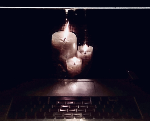 Candles mirrored in a computer screen