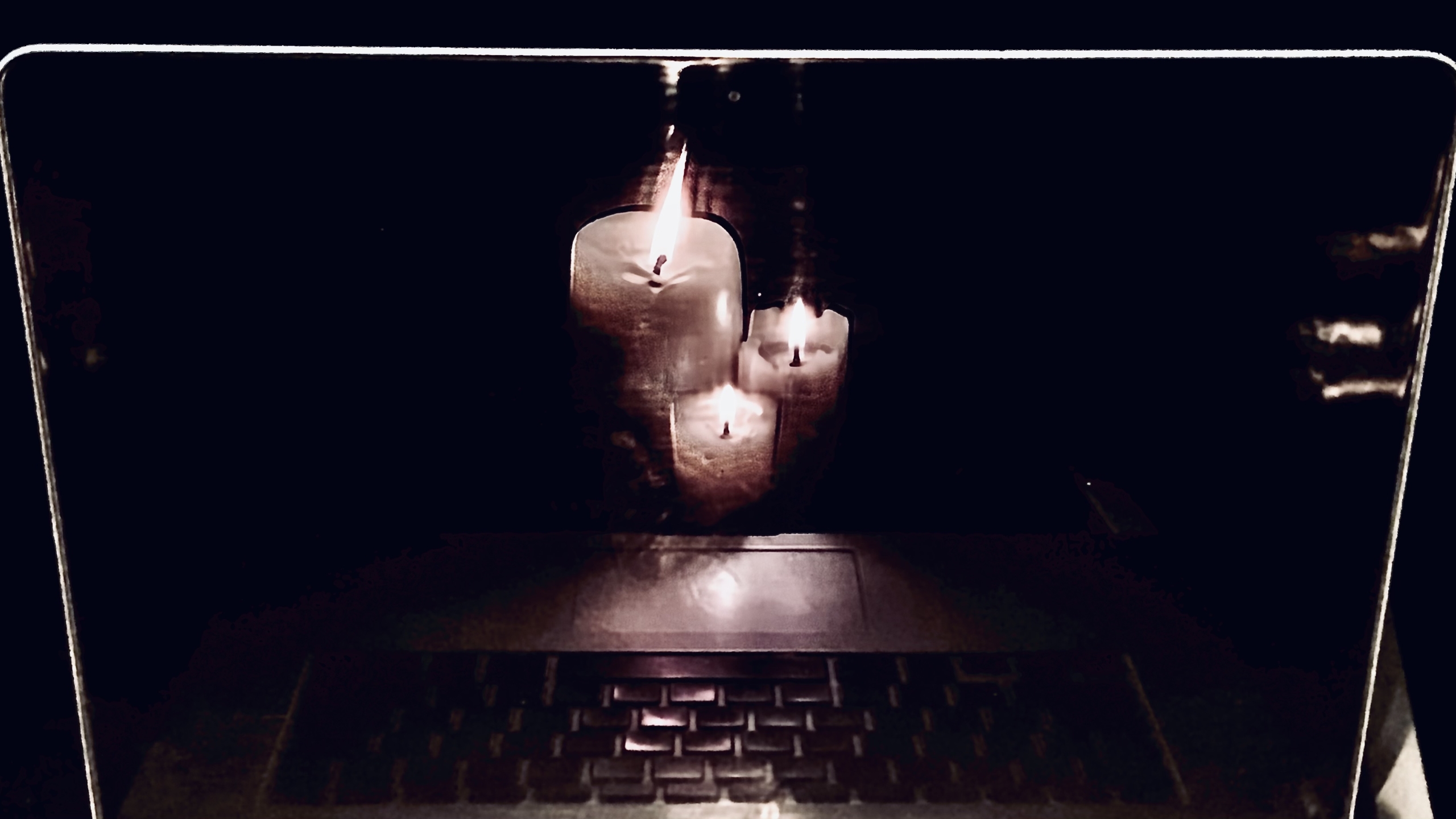 Candles mirrored in a computer screen